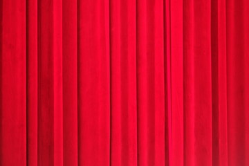 deep red closed curtain under bright stage light