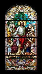 Obraz na płótnie Canvas Jesus blesses mothers with children, stained glass window in the Saint John the Baptist church in Zagreb, Croatia