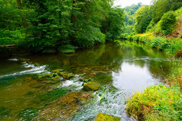 Fototapeta na wymiar Misty summer day beside the River Manifold in the Staffordshire Dales.