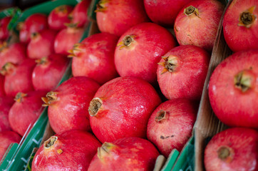 Background of ripe pomegranates for sale at the city farmers market