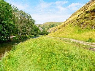 Fototapeta na wymiar Following the River Dove through the popular tourist destination of Dovedale in Derbyshire.