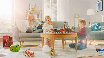 At Home: Cute Girl Playing in Video Game Console, Using Joystick Controller, Her Younger Brothe...