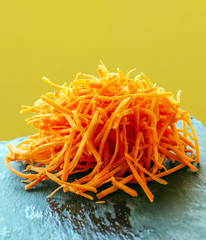 Carrot salad surrounded by yellow background