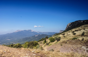 The mountains with a cloud overhead.Landscape of mountains and rocks. Green nature of stone mountain. Natural beauty. Nature of Crimea. Ukraine
