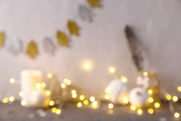 Christmas background with yellow lights and festive decor. Blurred image