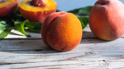 Fototapeta na wymiar Fresh peaches on a wooden background. Summer time.