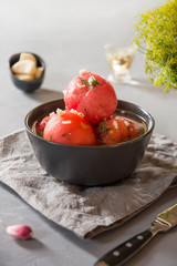 Marinated peeled tomatoes with garlic and dill, fresh ready to serve.