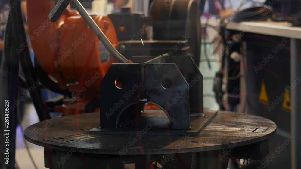 Poster automatic robotic arm making metal welding operations - concept for modern manufacturing process. me