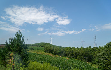 Wind power plants on the hills - green energy.