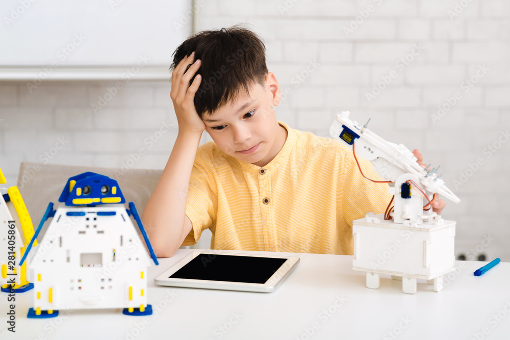Aufkleber Stem education. Boy creating robot at lab