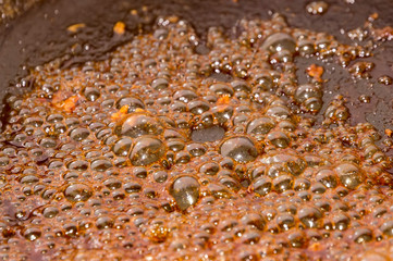 Detailed view of sugar caramelizing in a frying pan