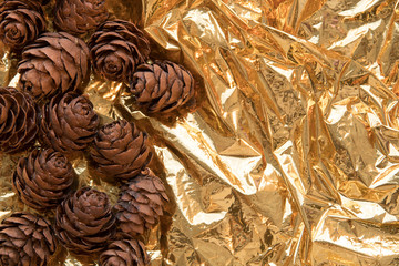 pine cone on a gold background. postcard for autumn and new year