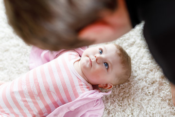 Happy proud young father with newborn baby daughter, family portrait together
