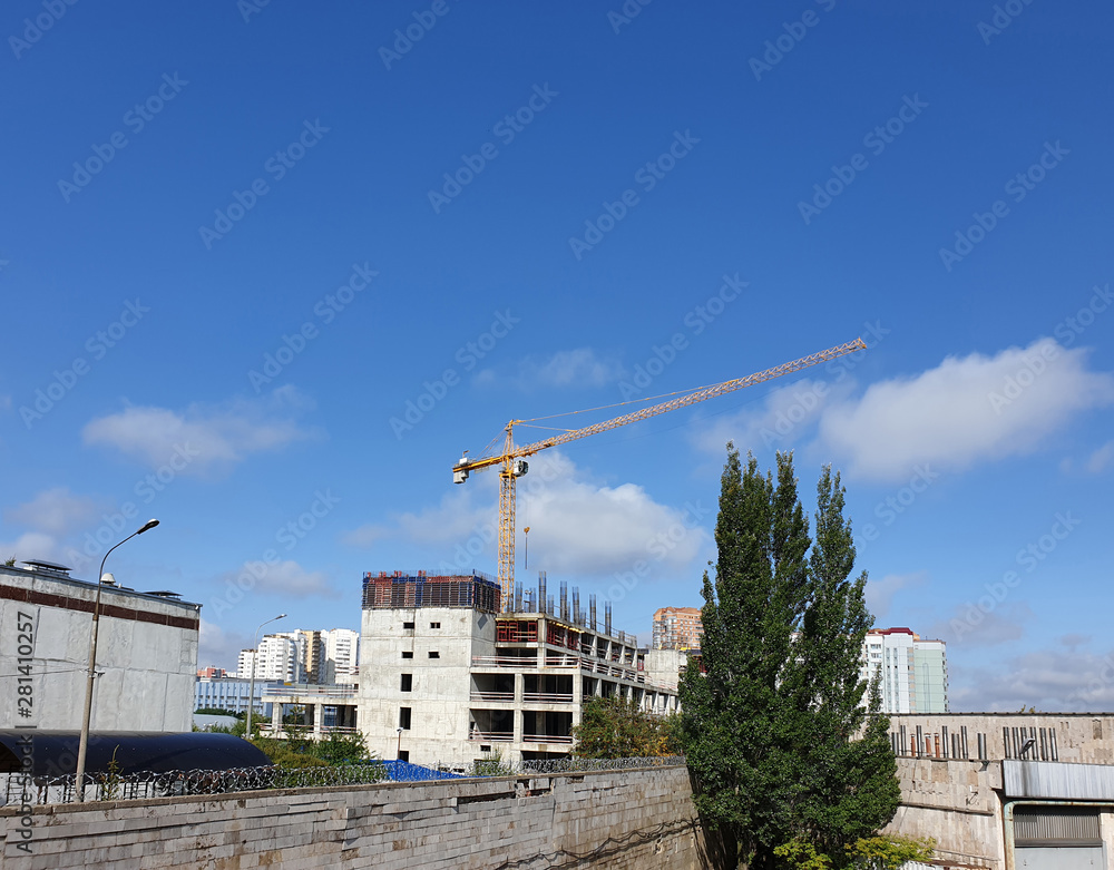 Poster example of point construction in a residential area. crane on the site of the building under constru