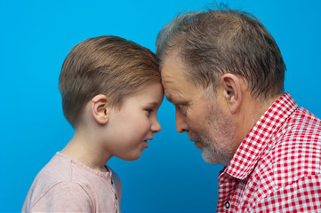 Close-up grandfather and grandson closely look