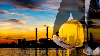 Double exposure of engineer with safety yellow helmet for workers security and black and white oil refinery industry plant background. Industrial 4.0, innovation, technology concept
