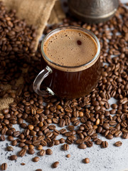 Turkish espresso coffee in a glass Cup on the table with coffee beans