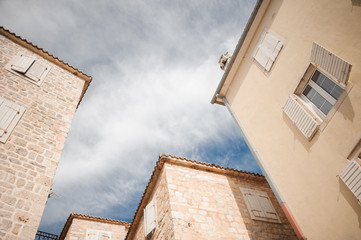 Fototapeta na wymiar the tops of medieval stone buildings against a cloudy sky