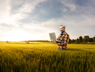 Beautiful senior farmer use new technology for agronomy
