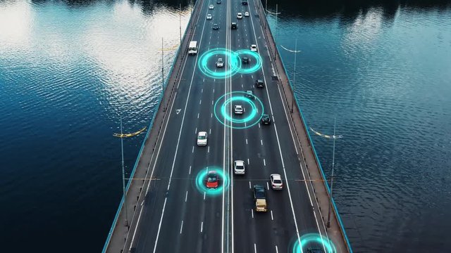 Self driving autonomous cars speeding through the bridge with technology scanning their speed. Artificial intelligence traffic surveillance system to provide safe driving avoid traffic jams. 4K aerial