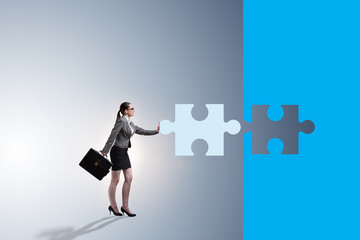 Concept of businesswoman with missing jigsaw puzzle piece