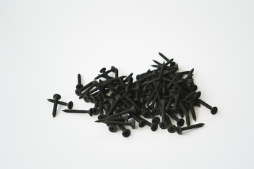 Black screws of self-tapping screws of same sizes isolated on white background.