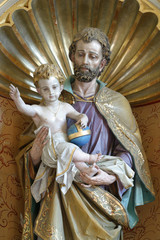 Saint Joseph holding child Jeaua, statue on the altar of Saint Joseph in the church of Our Lady of...
