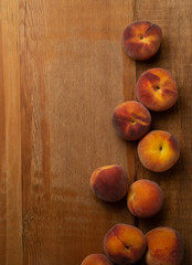 Fresh ripe peaches fruits on wooden rustic background. Top view.