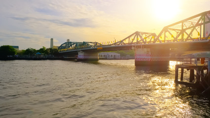 View of Phra Phuttha Yodfa Bridge At the Chao Phraya River, Memorial Bridge in transportation concept at Chao Phraya River. Bangkok at sunset