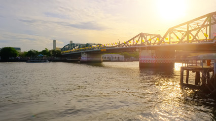 View of Phra Phuttha Yodfa Bridge At the Chao Phraya River, Memorial Bridge in transportation concept at Chao Phraya River. Bangkok at sunset