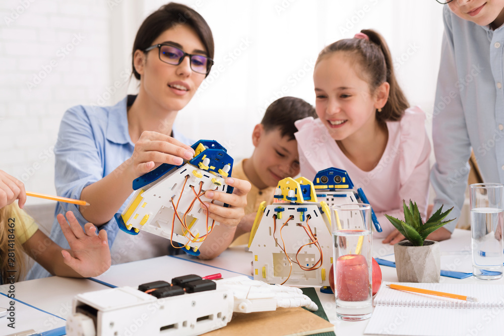 Poster stem education. kids constructing robots with teacher