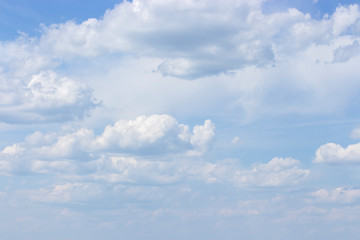 Naklejka na ściany i meble White powdery clouds on a clear blue sky, idyllic nature