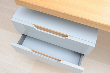 Furniture design: pull out empty drawers of modern sleek writing table in office cabinet