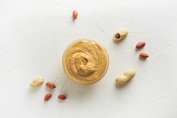 Peanut paste in glass gar. Healthy nutrition concept.