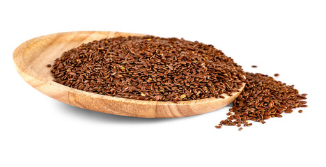 The flax seeds in a wooden plate isolated on a white background