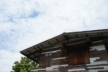 Fototapeta na wymiar Residential wooden houses and the sky backdrop in Thailand