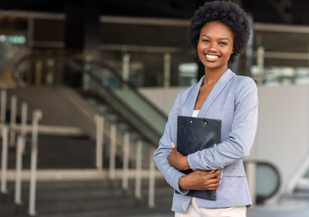 Female African American job seeker keeping a folder with CV - Powered by Adobe