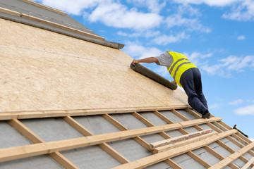 Building construction process of new wooden roof on wood frame house