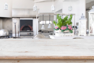 Fototapeta na wymiar Wooden table top on blurred modern restaurant kitchen room background