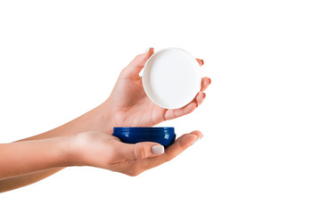 Female hand holding cream bottle of lotion isolated. Girl opening jar cosmetic products on white background
