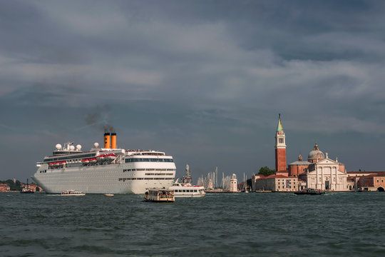 Scenic evening in amazing and budy Venetian Grand Canal with many boats and big cruise ship, Venice, Italy, summer time