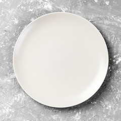 Top view with empty for you design. Empty white plate on wooden background
