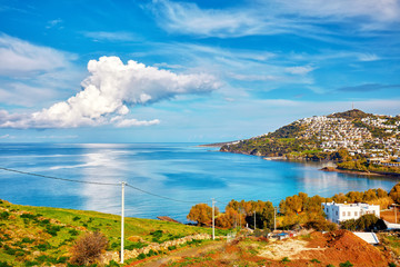 From above view of Cukurbuk bay, turquoise sea, clouds, mountain and settlements in Bodrum,...