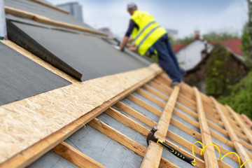 Building construction process of new wooden roof on wood frame house
