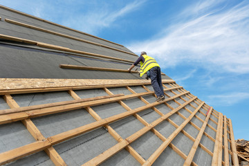 Building construction process of new wooden roof on wood frame house