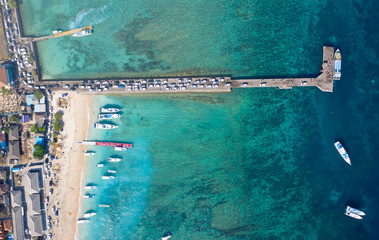 Holiday Concept Background. Top Down Drone Shot of Cars Entering Nusa Penida Island via Toya Pakeh...