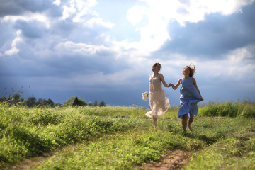 Young girls are walking in the field