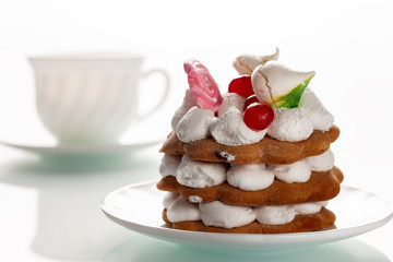 Cake with protein cream on a white glass table