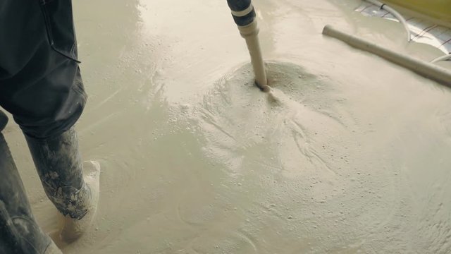 Pouring concrete floor in family house. Anhydrite is optimal binder for production of anhydrite floor screeds. Used as basis for self-leveling poured floors. Construction industry works on building