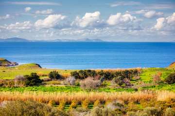 Obraz premium From above view of a meadow field sea sky and clouds in Gumusluk, Bodrum Mugla Turkey